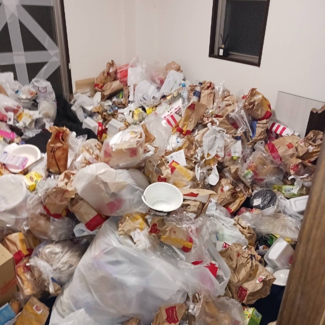 清掃前:大量のゴミで床が見えない散らかった部屋